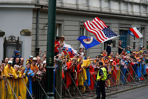 The U.S. flag is seen as pilgrims cheer as Pope Francis arrives on a tram for the World Youth Day welcoming ceremony in Blonia Park in Krakow, Poland, July 28. (CNS photo/Paul Haring)