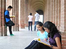 Students talking in a campus breezeway. iStock photo.