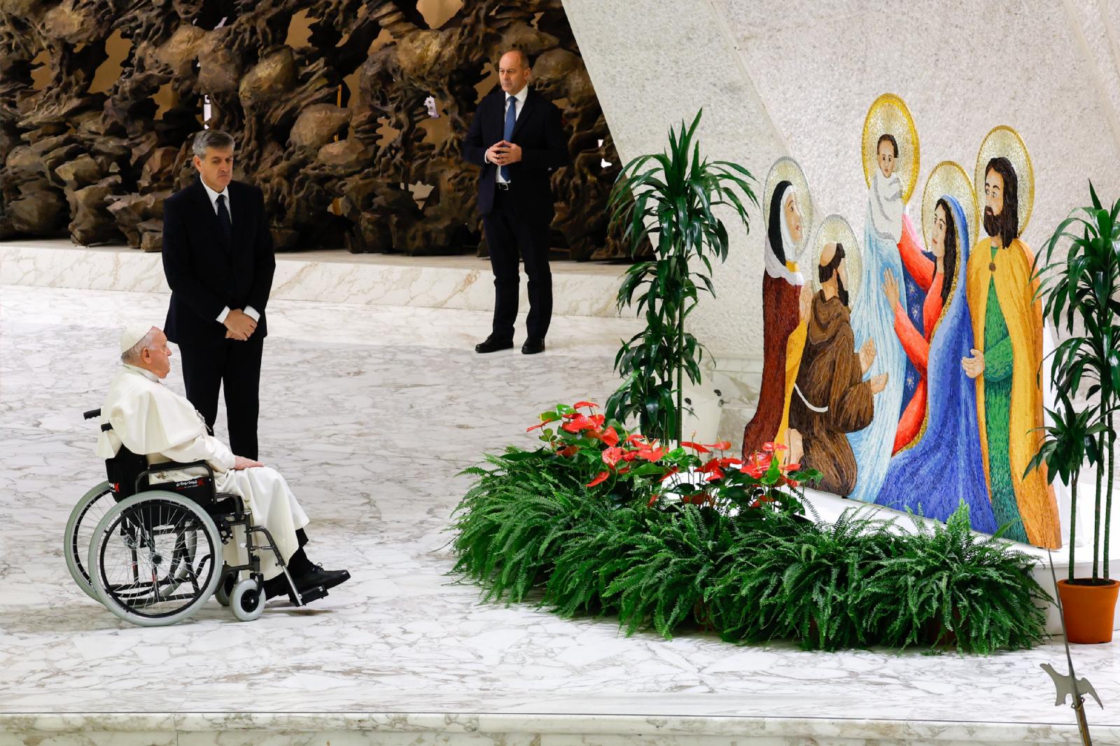 Pope Francis prays before Nativity scene