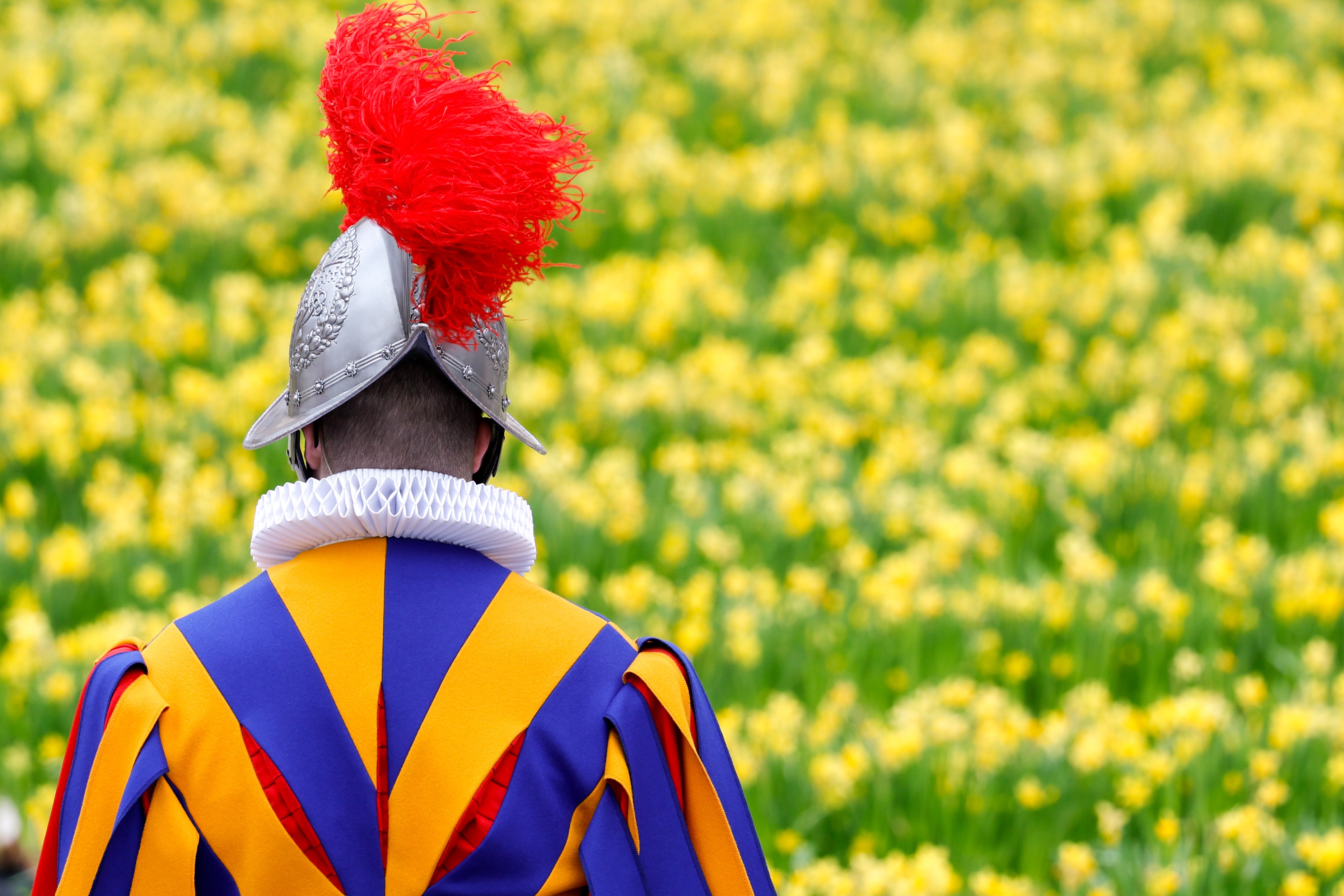A Swiss guard faces flowers during Pope Francis' Easter Mass. 
