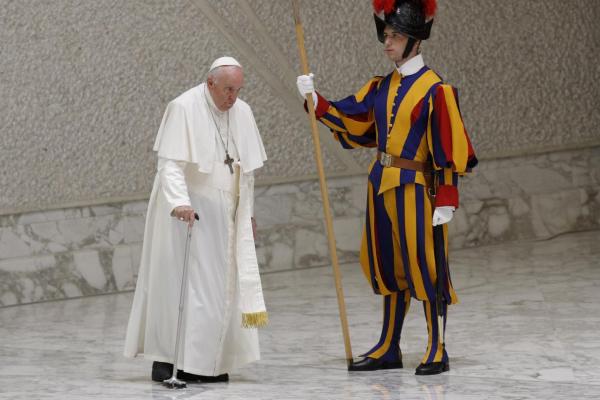 Pope Francis arrives at his general audience using a cane