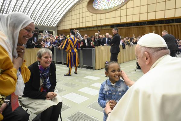 Pope Francis greets child