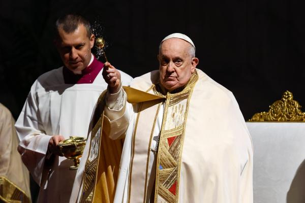 Pope Francis blesses candles.