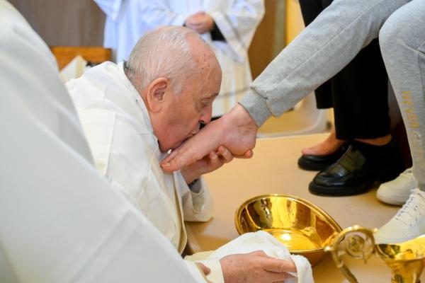 Pope Francis kisses an inmate's food
