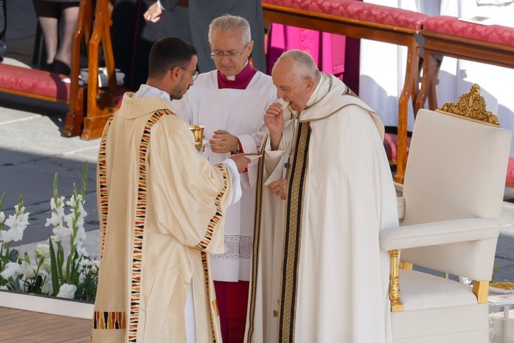 Pope Francis receives Communion.