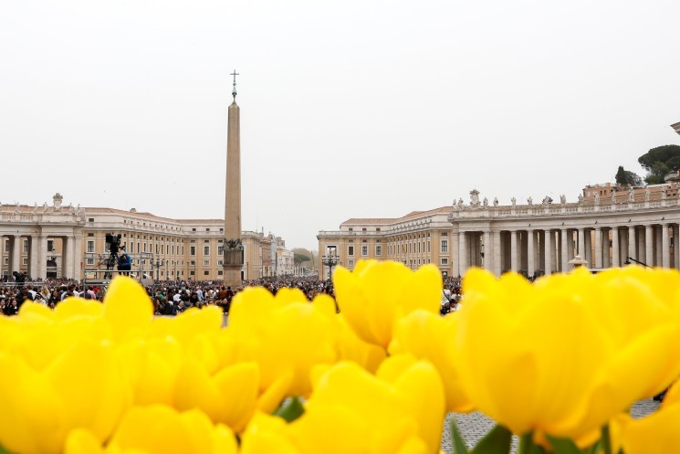 The obelisk in St. Peter’s Square rises over a display of yellow tulips in St. Peter's Square.